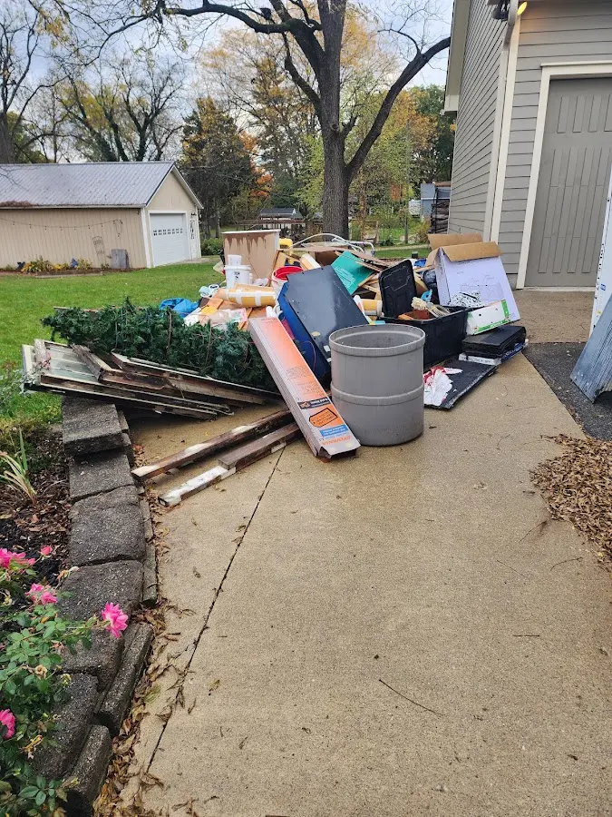 Dumpster being loaded with debris for Commercial Dumpster Rental in Pell City